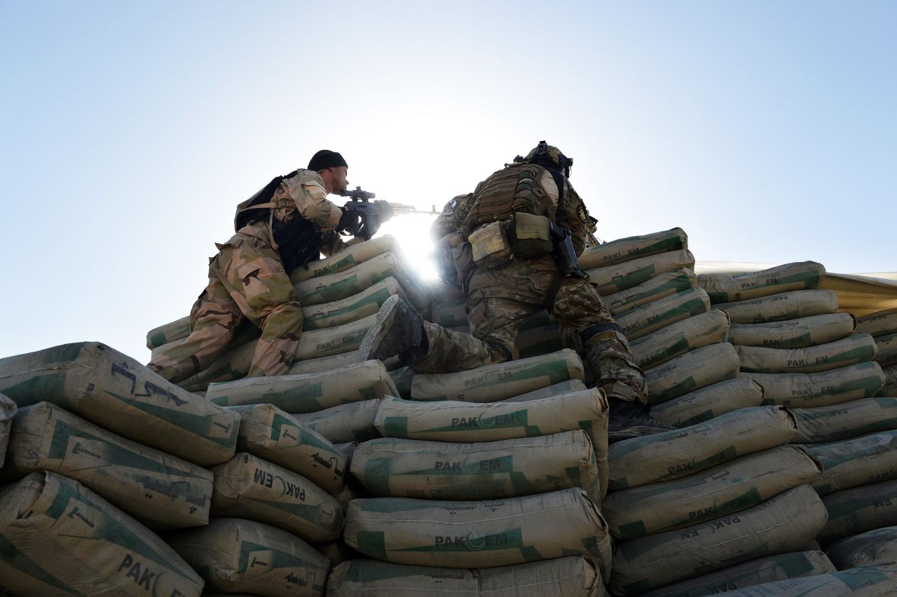 A member of the Afghan Crisis Response Unit, left, and a coalition solider during the June 10 attack.