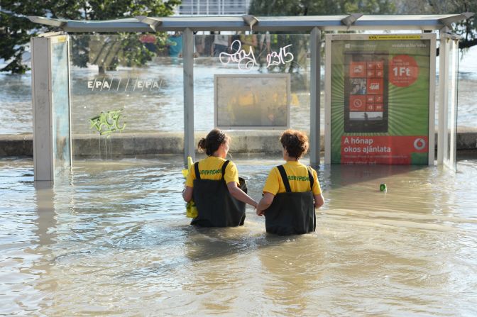 Greenpeace activists walk in floodwaters from the Danube at the Chain Bridge in Budapest on June 9. 