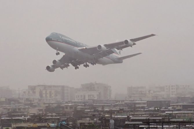 <strong>Scary moments: </strong>Watching planes land in heavy rain is one of Chapman's scariest memories."Here's a CX 747-200 getting a little low in the rain," says the photographer. "Some (pilots) seemed to wait a little longer than others before they aborted the landing and went around for another go. Some would appear out of the low clouds on the approach path then power up and vanish back into the clouds."