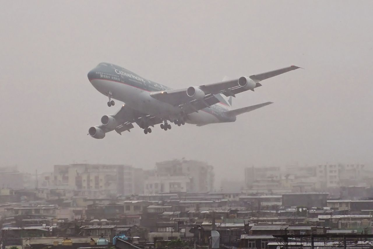<strong>Scary moments: </strong>Watching planes land in heavy rain is one of Chapman's scariest memories."Here's a CX 747-200 getting a little low in the rain," says the photographer. "Some [pilots] seemed to wait a little longer than others before they aborted the landing and went around for another go. Some would appear out of the low clouds on the approach path then power up and vanish back into the clouds."