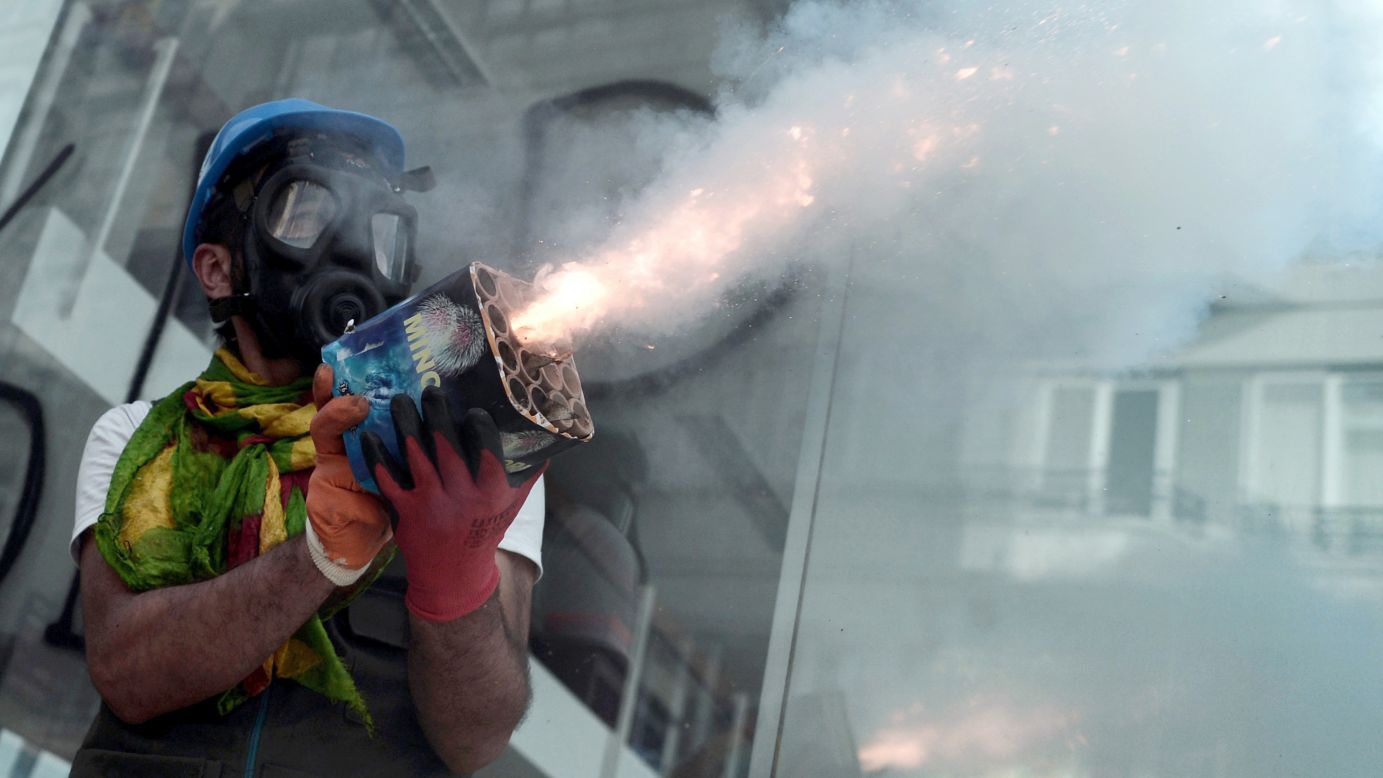 A protester holds fireworks during clashes with riot police in Istabul on June 11.