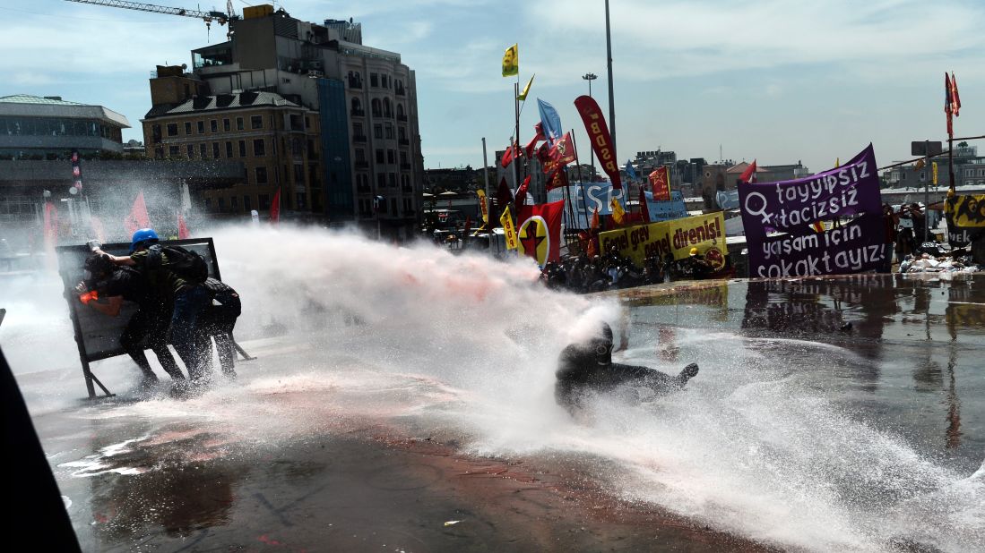 Police fire a water cannon at protesters on June 11.