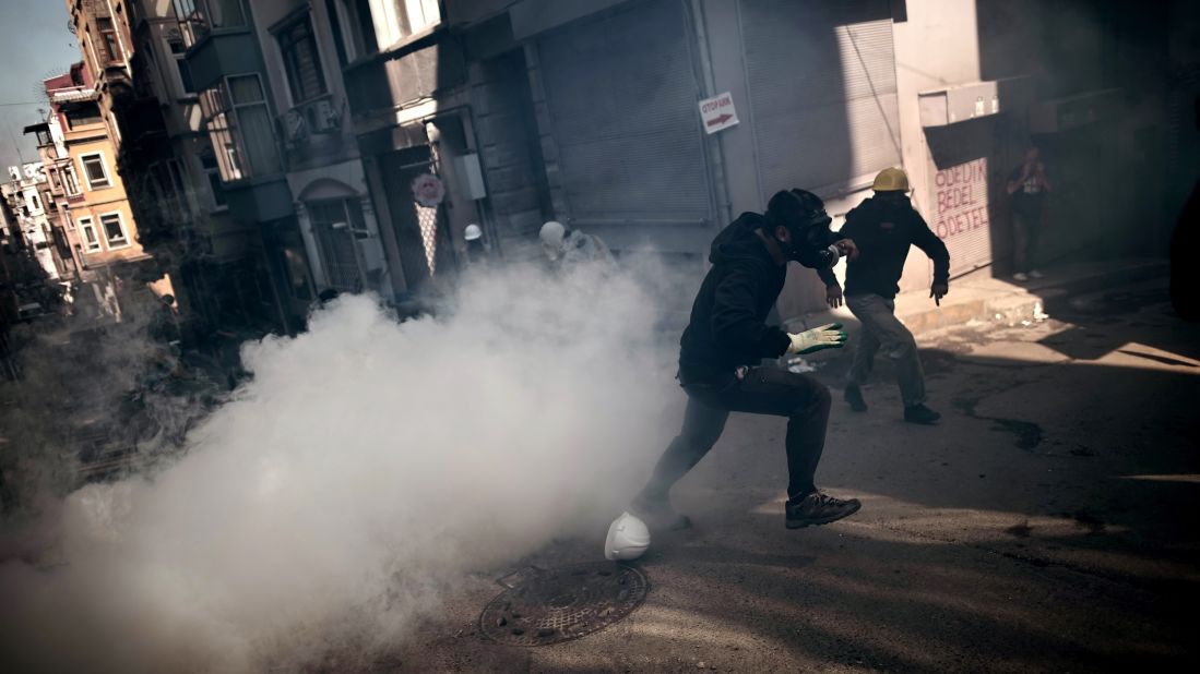 Protesters run from smoke as they clash with police in Istanbul on June 11.