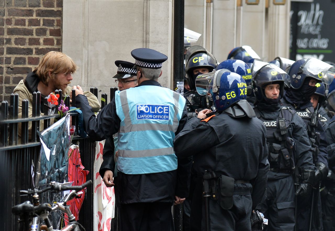 Police speak with a protestor on Beak Street in Soho, central London, on June 11.
