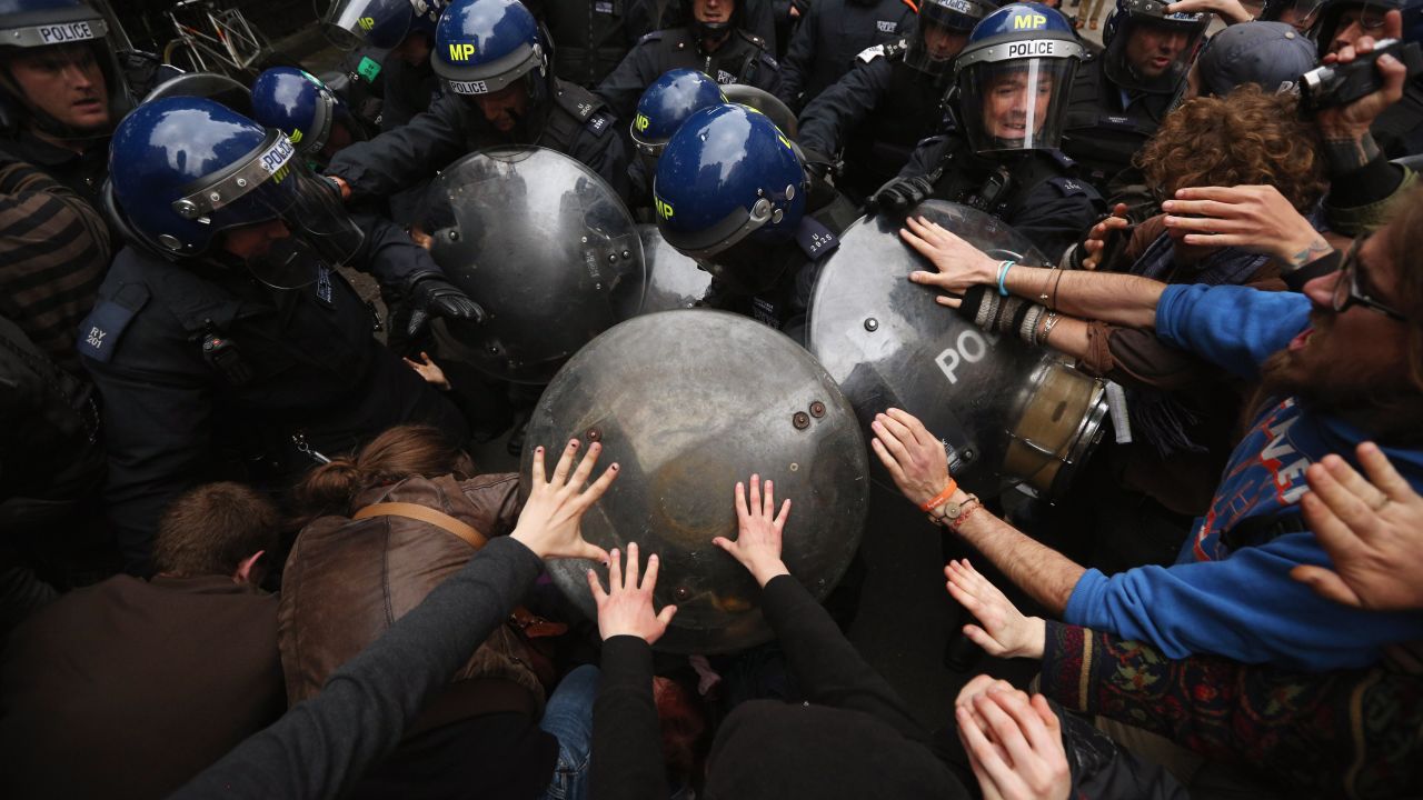 Riot police clash with protesters in London's Golden Square on Tuesday, June 11, during a demonstration ahead of the Group of Eight summit in Northern Ireland.