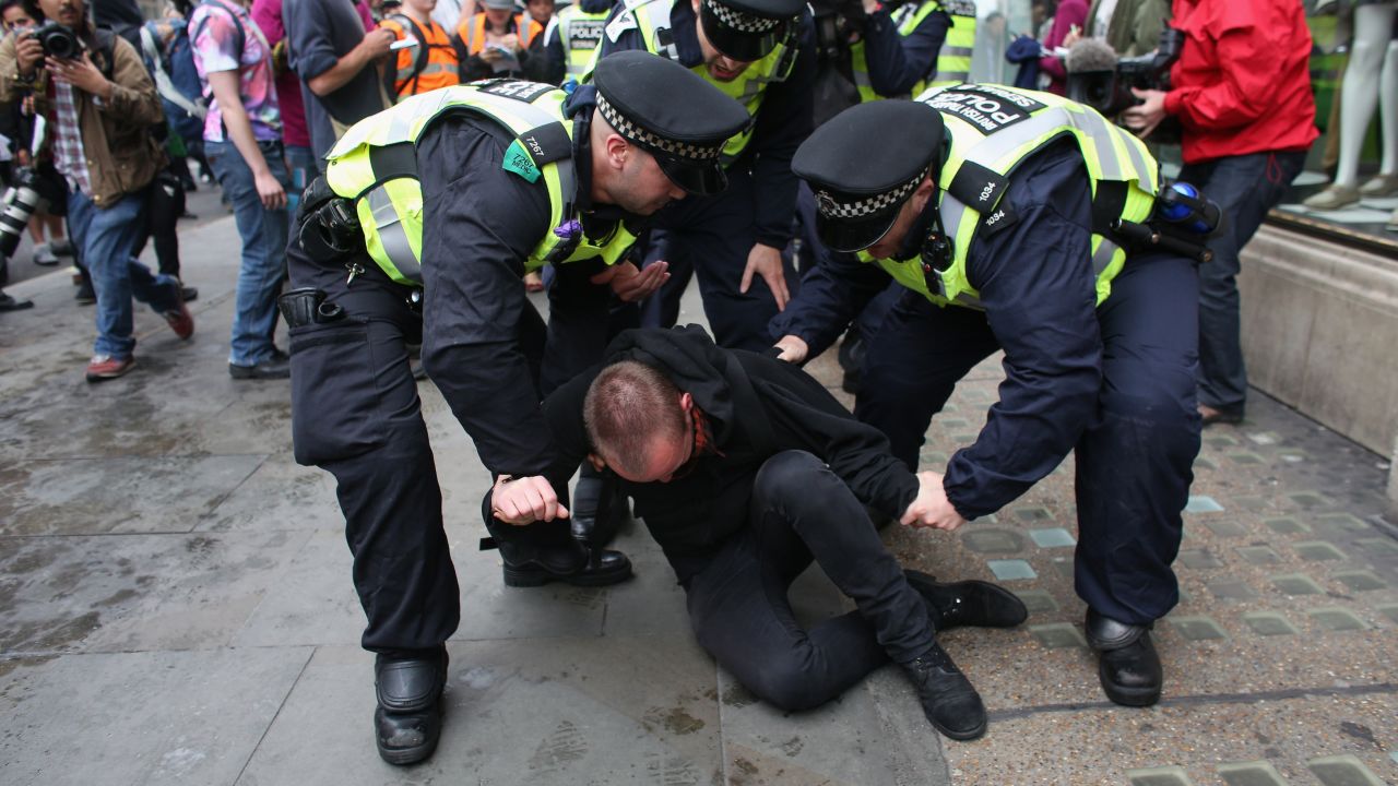 A protester is detained on Oxford Street in London on June 11.