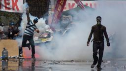 Protestors wear gas masks as riot police use water cannons and tear gas to disperse the crowd during a demonstration near Taksim Square on June 11, 2013 in Istanbul, Turkey. 