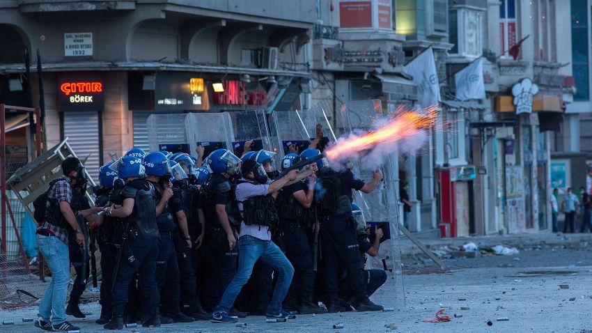 ISTANBUL, TURKEY - JUNE 11: Riot police fire tear gas to disperse the crowd during a demonstration near Taksim Square on June 11, 2013 in Istanbul, Turkey. Istanbul has seen protests rage on for days, with two protesters and one police officer killed. What began as a protest over the fate of Taksim Gezi Park, has turned, with the heavy-handed response by police, into a protest over what is being seen as Prime Minister Recep Tayyip Erdogan's increasingly authoritarian agenda. (Photo by Lam Yik Fei/Getty Images) 