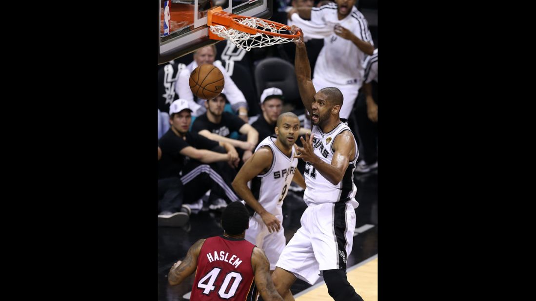 Tim Duncan of the San Antonio Spurs dunks the ball over Udonis Haslem of the Miami Heat.