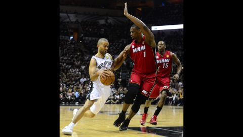 Tony Parker of the San Antonio Spurs dribbles under pressure from Chris Bosh of the Miami Heat.