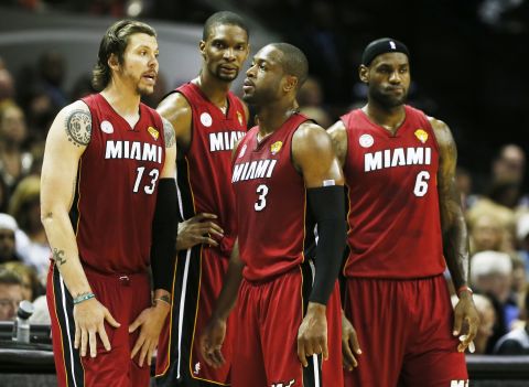 From left, Miami Heat's Mike Miller, Chris Bosh, Dwyane Wade and LeBron James talk during a break in the game.