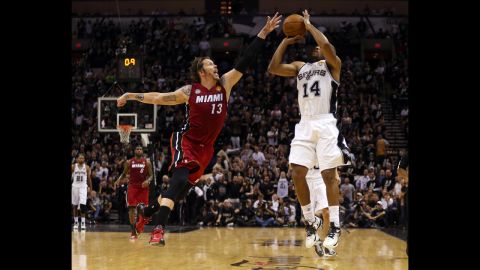 Gary Neal of the San Antonio Spurs makes a three-pointer over Mike Miller of the Miami Heat during the second quarter.
