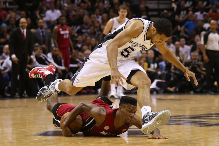 Cory Joseph of the San Antonio Spurs and Norris Cole of the Miami Heat go after a loose ball in the second half.