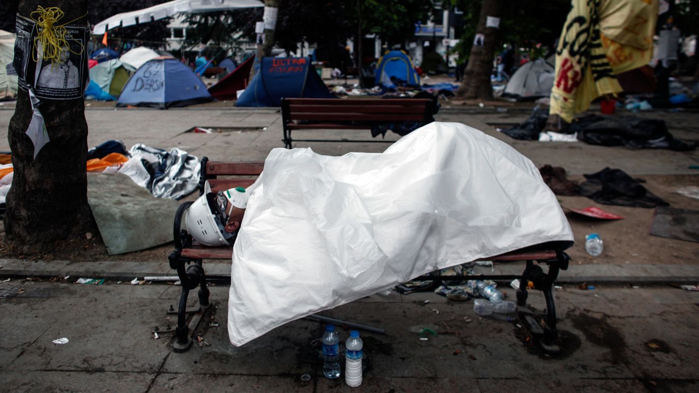 A man sleeps in Gezi Park in Istanbul's Taksim Square early on June 12, hours after riot police moved into the square in an attempt to push demonstrators out. 