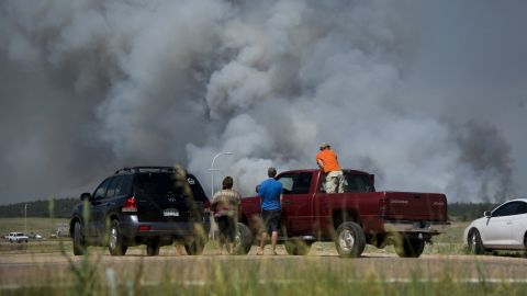 Motorists stop along Interquest Parkway in Colorado Springs on June 11 to watch the advance of a wildfire burning in the Black Forest.