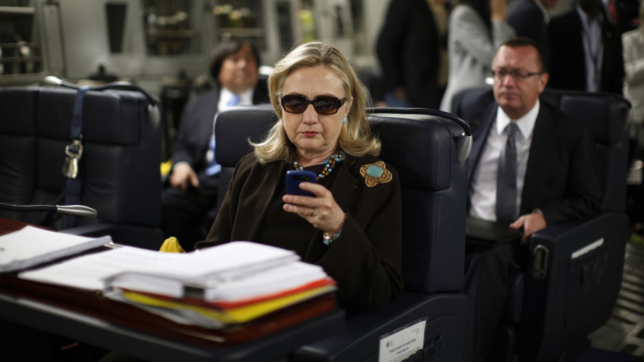 U.S. Secretary of State Hillary Clinton checks her PDA upon departure in a military C-17 plane from Malta bound for Tripoli, on October 18, 2011. AFP PHOTO/KEVIN LAMARQUE/POOL (Photo credit should read KEVIN LAMARQUE/AFP/Getty Images)