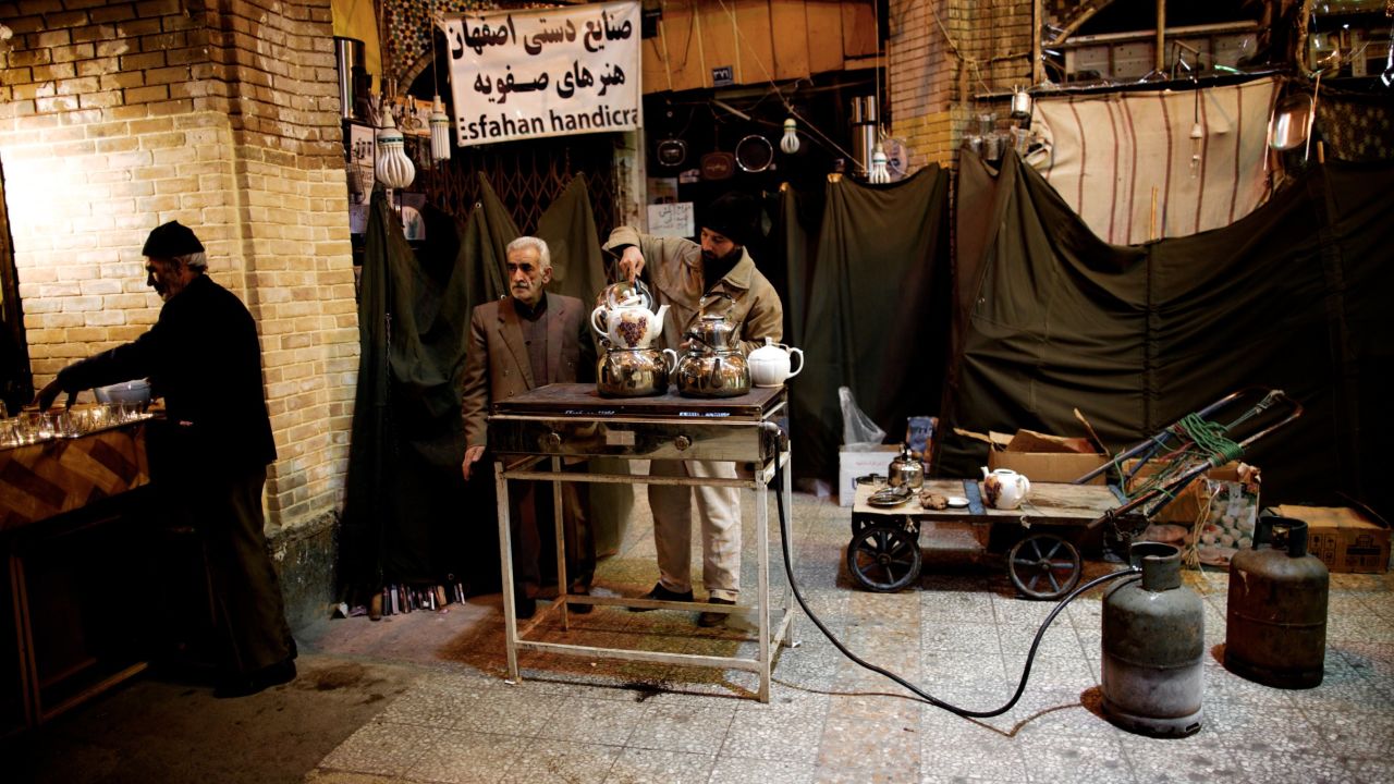 Iranian Shiite Muslims prepare some tea for the mourners at Tehran's Grand Bazaar, on January 3, 2013 during the Arbaeen religious festival which marks the 40th day after Ashura, commemorating the seventh century killing of Prophet Mohammed's grandson, Imam Hussein. AFP PHOTO/BEHROUZ MEHRI (Photo credit should read BEHROUZ MEHRI/AFP/Getty Images)