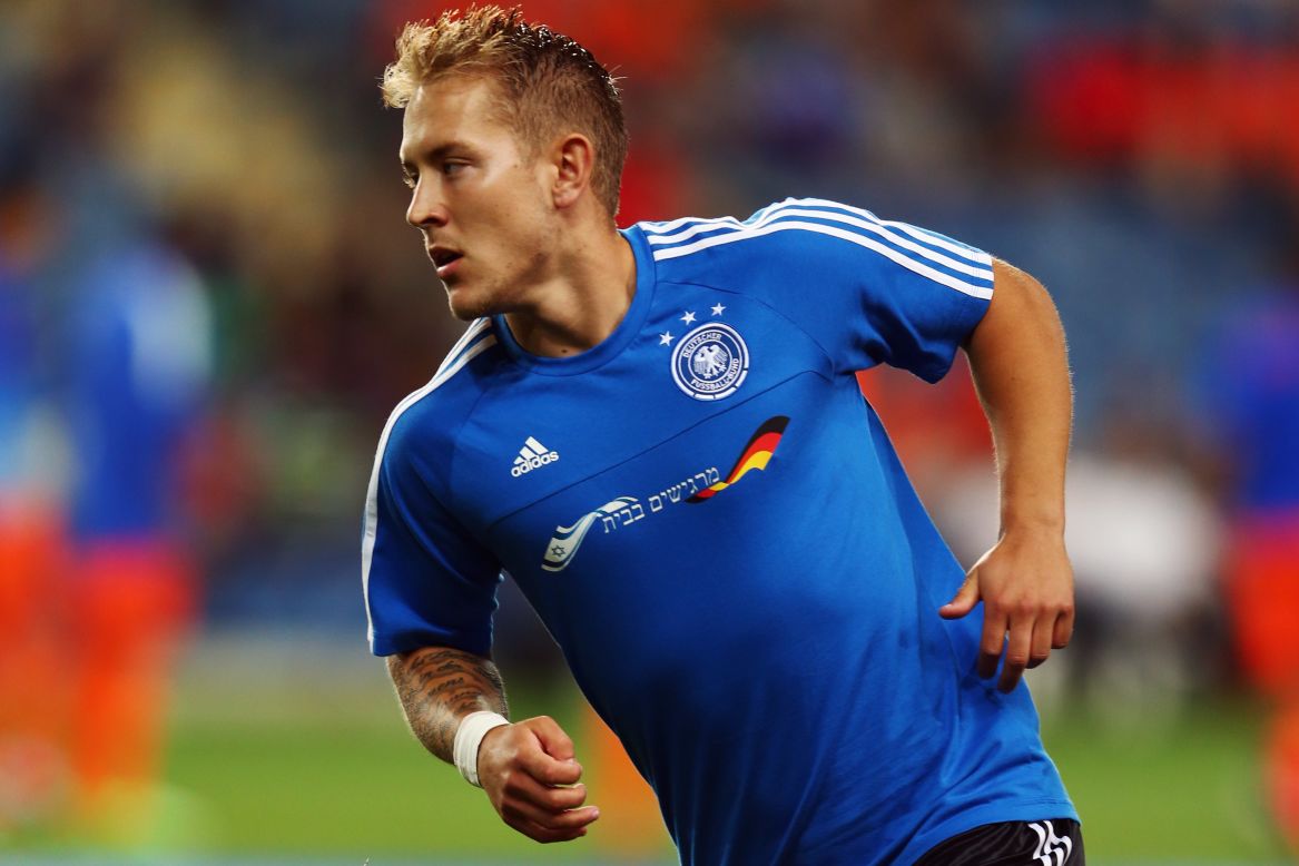 Germany captain Lewis Holtby wears a specially made training shirt with the Israeli flag and the words "Feeling at home" embroidered on the front to thank the host fans for making the team welcome at the European Under-21 Championship.