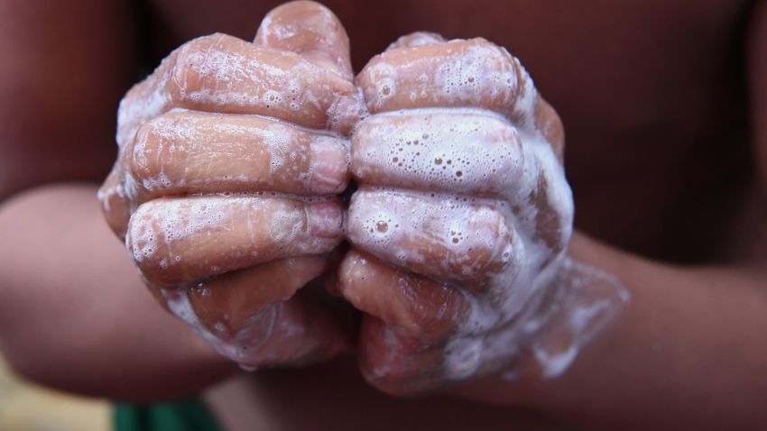 A Rohingya refugee child demonstrates the best way to wash hands during a demonstration on importance of hand washing and sanitation by ICRC on the eve of Global Handwashing Day at the Balukhali refugee camp in Ukhia district on October 14, 2017.
The United Nations on October 10 launched one of its biggest ever cholera vaccination drives in the vast refugee camps of southeast Bangladesh amid fears of an outbreak among nearly a million Rohingya now living there. / AFP PHOTO / INDRANIL MUKHERJEE        (Photo credit should read INDRANIL MUKHERJEE/AFP/Getty Images)