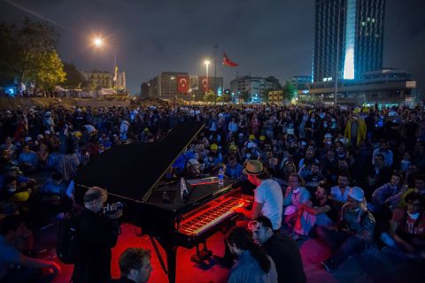 A man plays piano for hundreds of protesters in Taksim Square on Wednesday, June 12, in Istanbul.