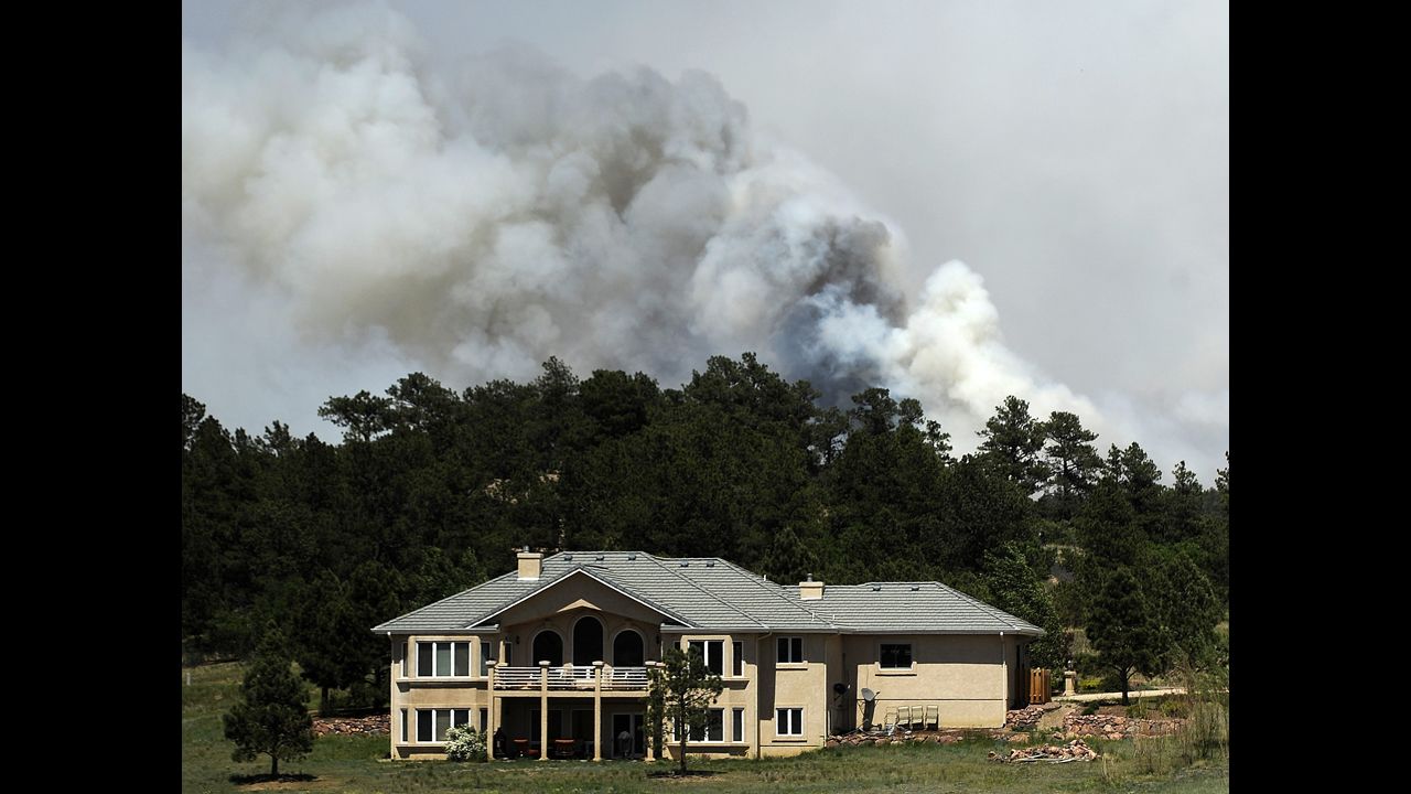 Smoke billows from the Black Forest Fire near a house north of Colorado Springs on June 12.