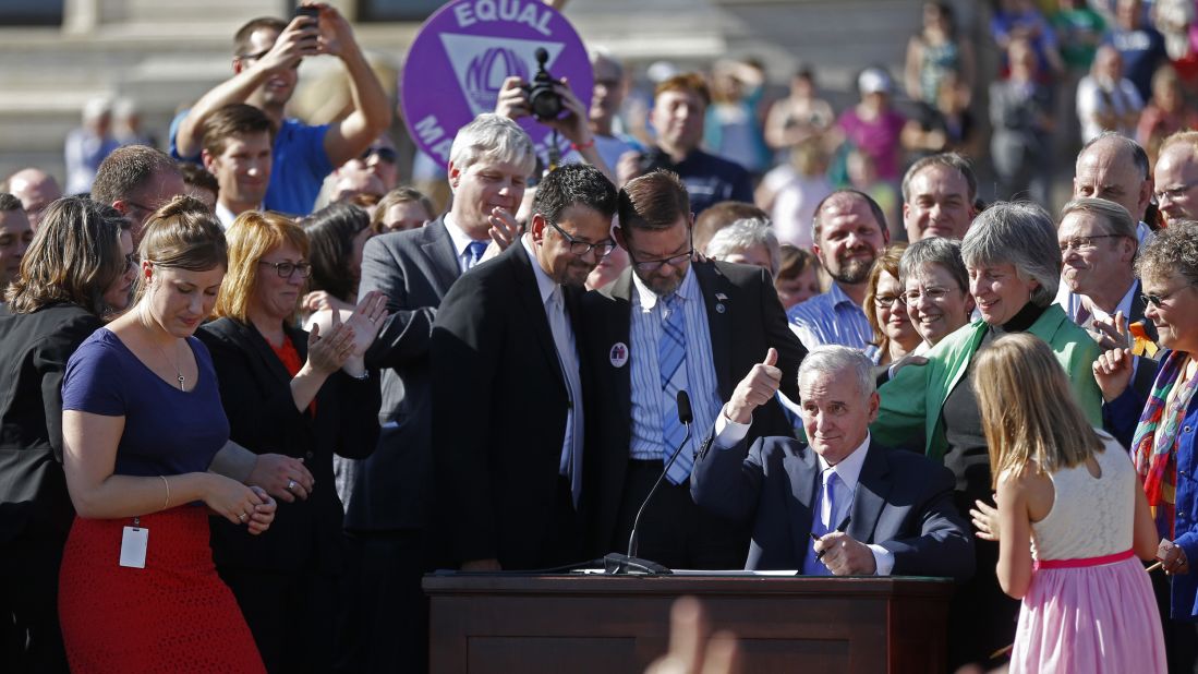 At the state Capitol in St. Paul, Minnesota, Gov. Mark Dayton signs a bill legalizing same-sex marriage on May 14, 2013.