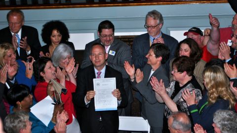 Delaware Gov. Jack Markell holds up legislation on May 7, 2013, allowing same-sex couples to wed in the state.