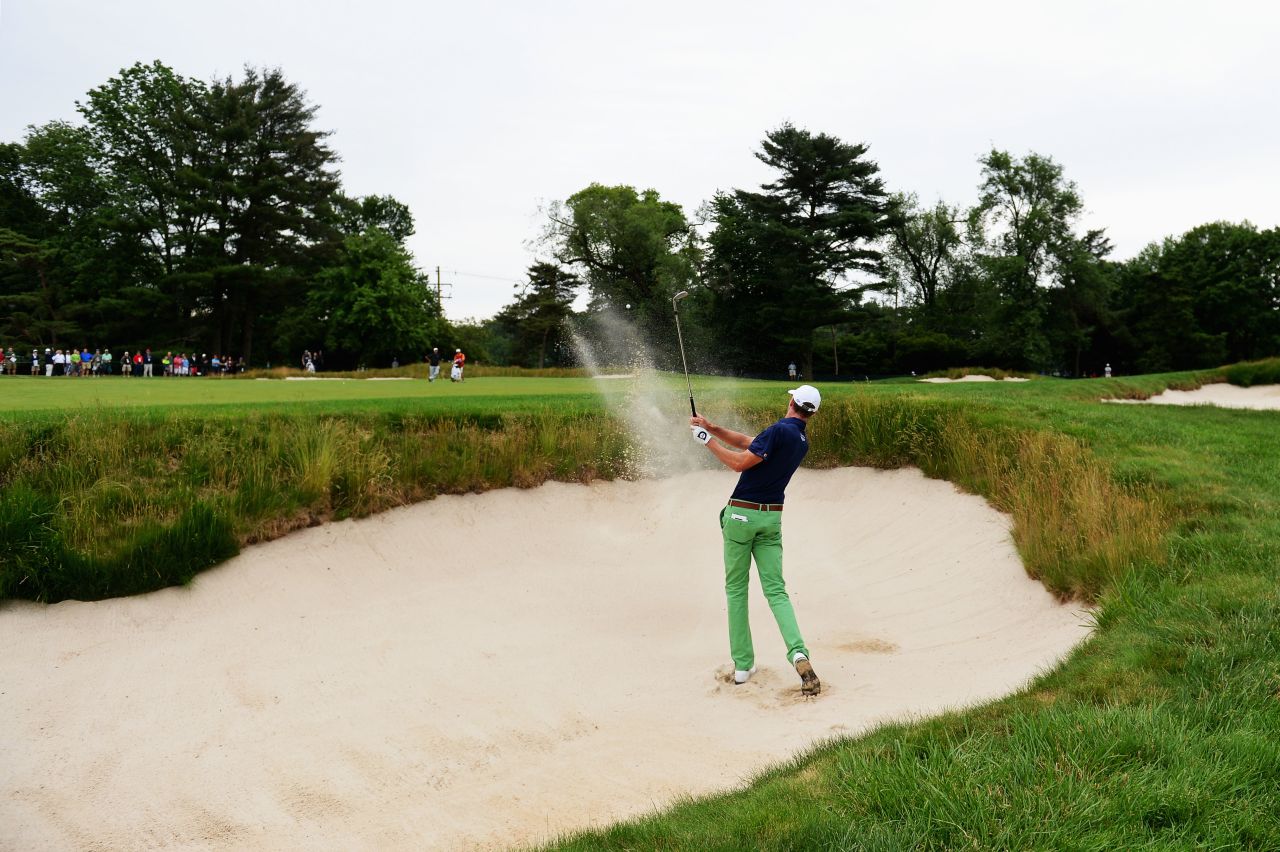 Roger Tambellini of the United States hits his second shot from a bunker on the first hole on June 13.