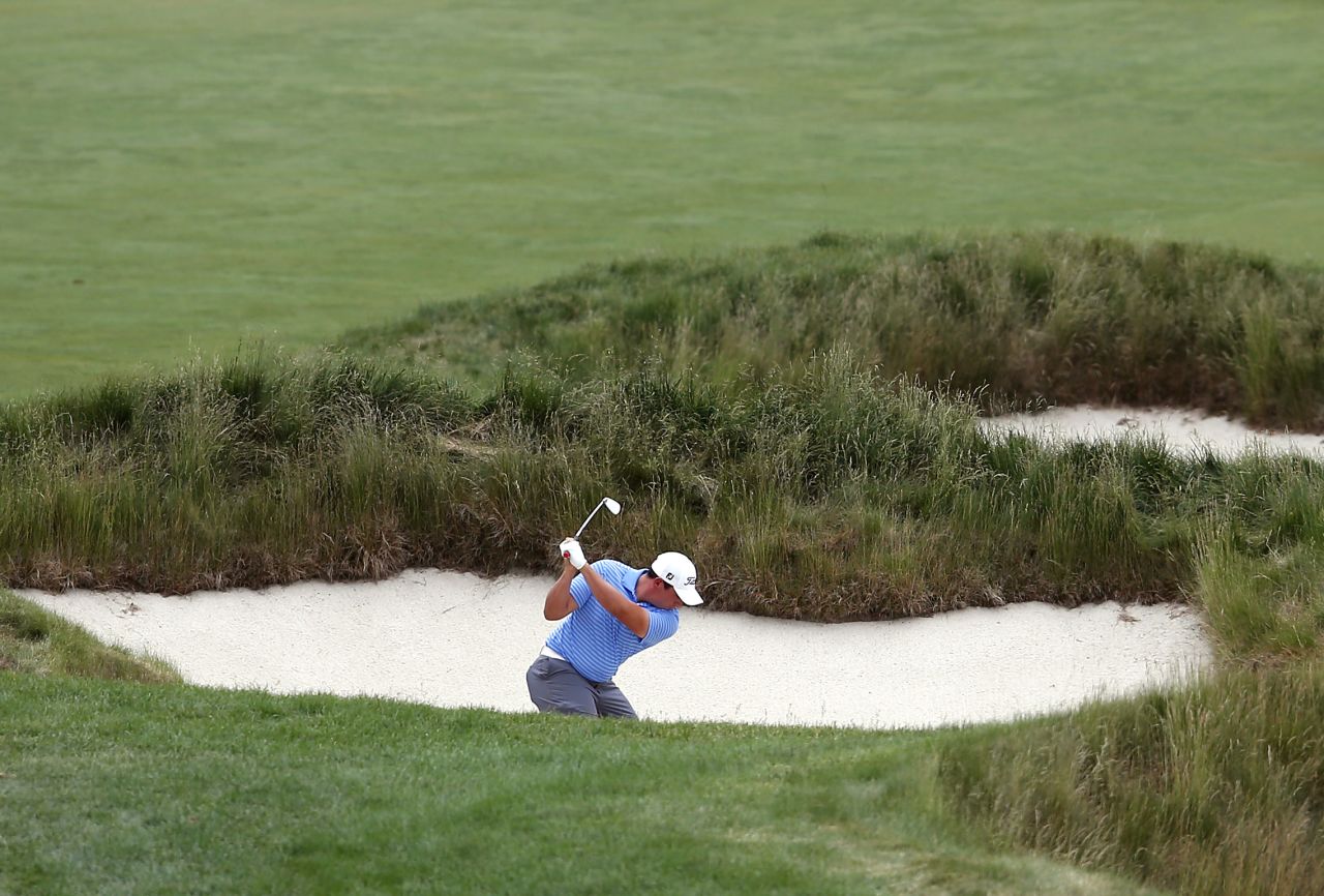 Scott Stallings of the U.S. shoots from a bunker on the 15th hole on June 13.