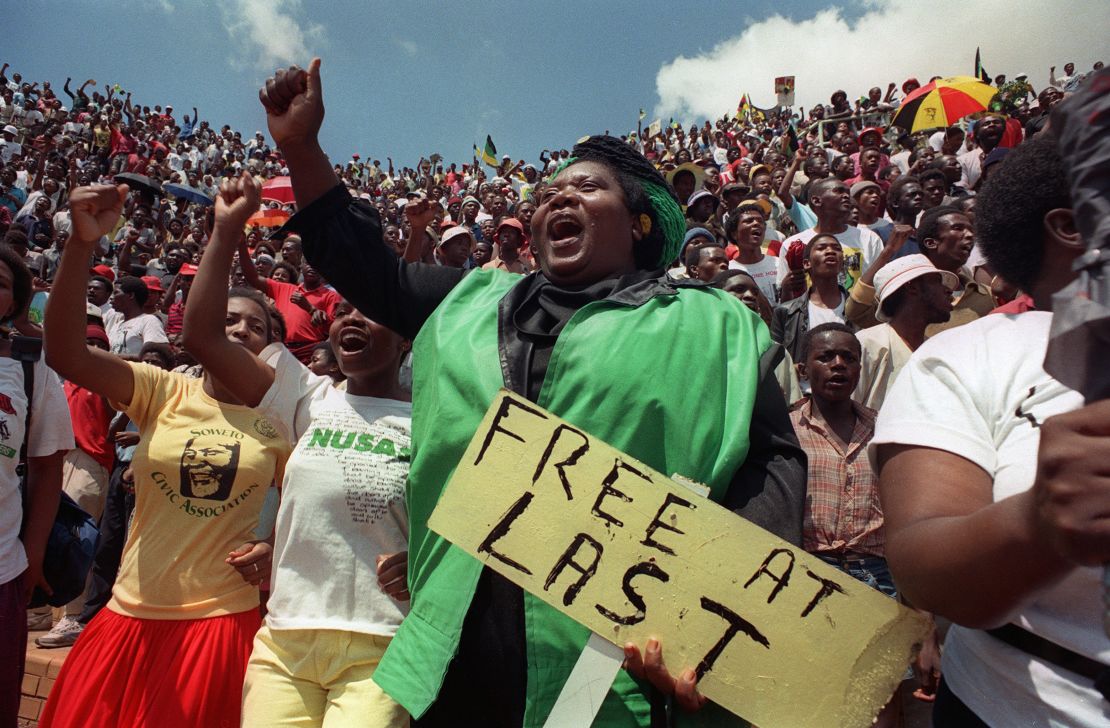 Jubilant residents of Soweto wait to hear newly freed Nelson Mandela speak at Orlando stadium February 12,1990. I
