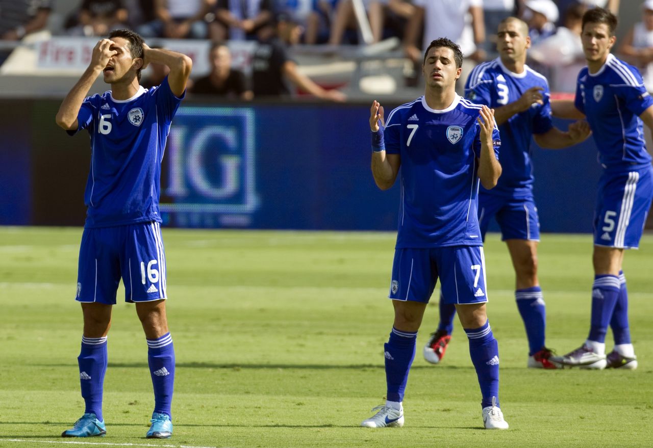 Israel's Jewish player Eran Zahavi (L) and Muslim player Beram Kayal (R) pray before the start of a Euro 2012 qualifier in 2011. The Under-21 squad which competed in this year's European Championship Finals included five Israel-Arabs, two Ethiopians and a Bedouin.