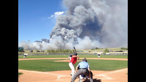 A baseball game goes on despite a raging wildfire in Colorado on Wednesday, June 12.