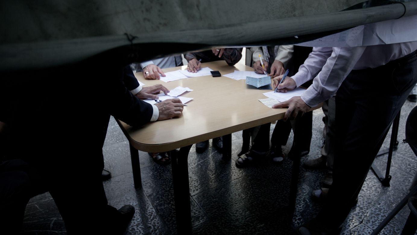 Voters fill out paper ballots in Tehran on June 14.