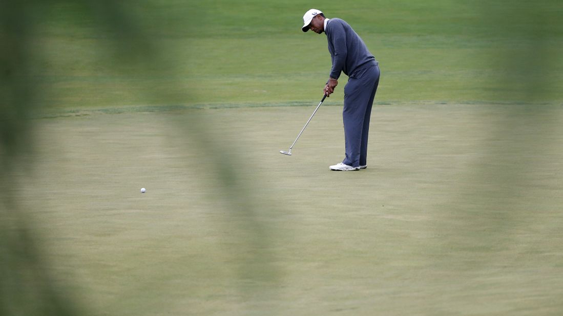 Tiger Woods of the United States putts on the 14th hole on June 14.