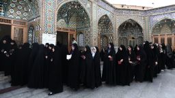 Iranian women wait in a queue to vote at a polling station at the Massoumeh shrine in the holy city of Qom, 130 kms south of Tehran, during presidential elections in the Islamic republic on June 14, 2013.