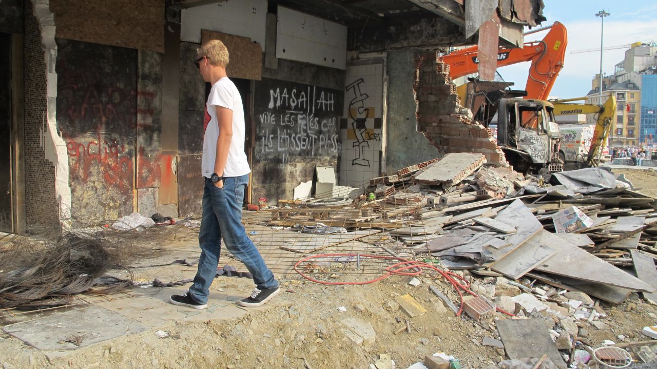 18-year-old holidaymaker Stenver Koop walks amongst building debris after the recent clashes in Istanbul's Taksim Square.