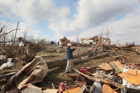Insurance adjuster Mark Ricketts photographs a home destroyed by a tornado in Henryville, Indiana, on March 4, 2012. Tornadoes and severe weather that struck the Ohio valley and southeast on March 2 and March 3 caused about $3.1 billion in losses.