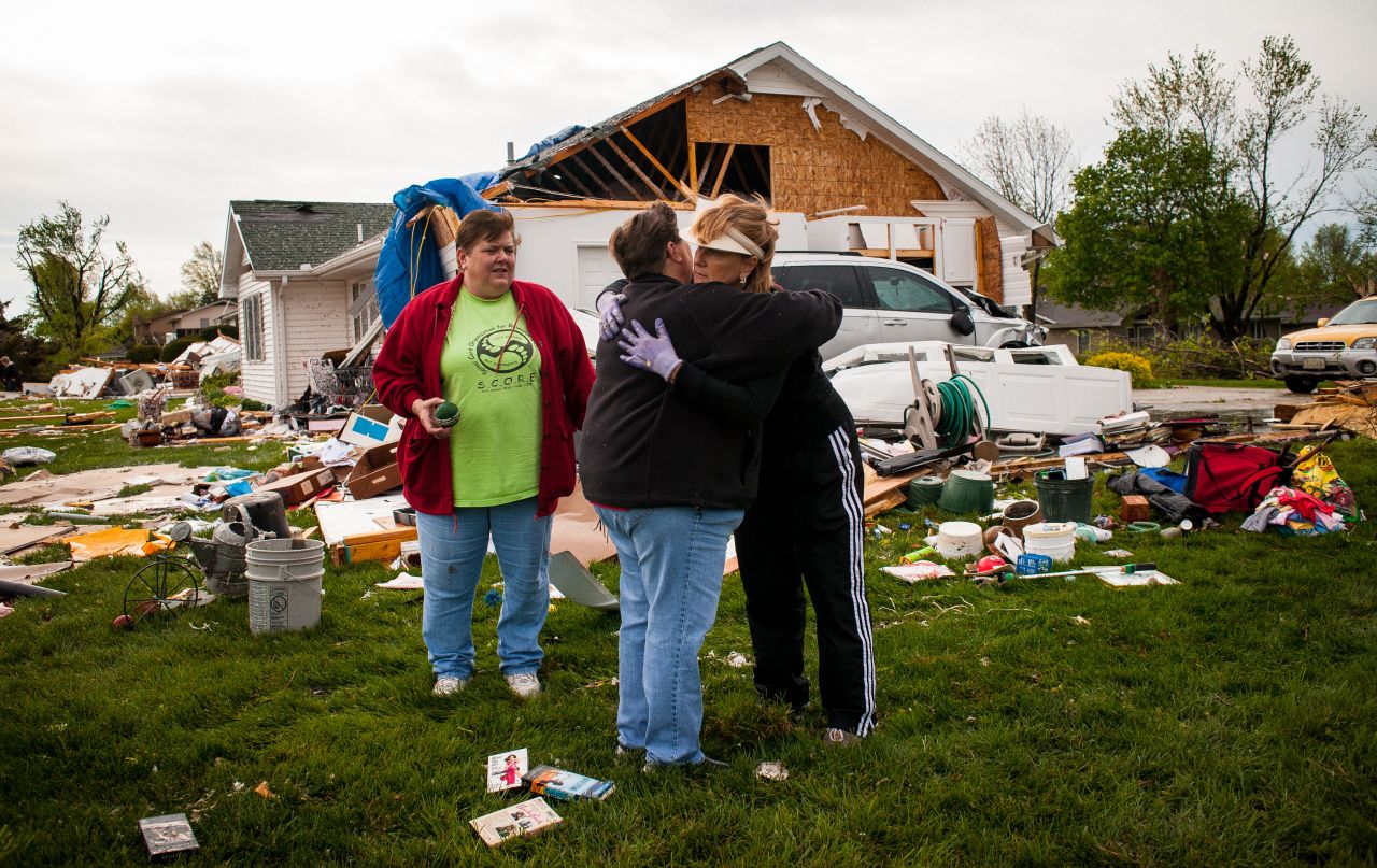 Two women embrace while surveying the damage left in the wake of a tornado that hit Creston, Iowa, on April 15, 2012. An outbreak of tornadoes in the Midwest on April 13 and April 14 caused about $1.1 billion in losses.