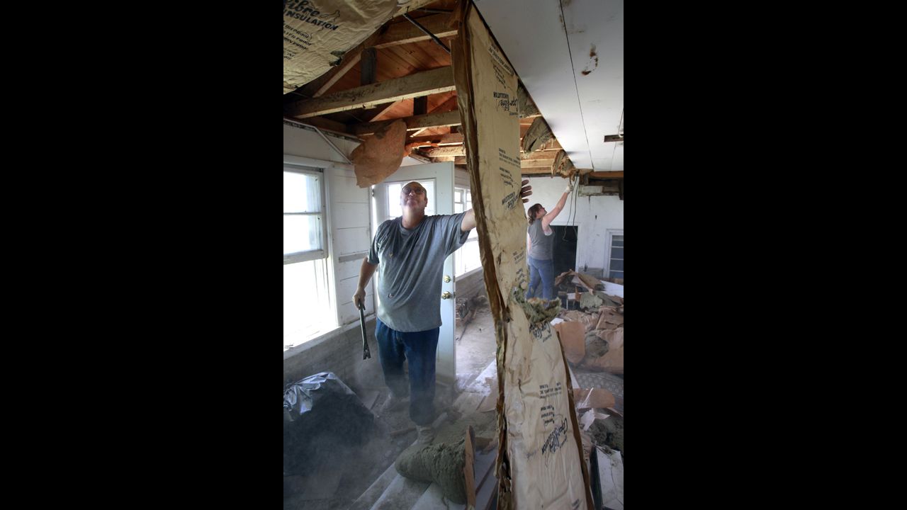 Delbert Wilcox, left, and his granddaughter Samantha Vermillion work to salvage lumber and wiring from the home of Ken Knox on May 30 in northern Platte County, Missouri. Severe weather from the Plains to the Northeast in late April and late May 2012 caused an estimated $3.3 billion and $2.3 billion in losses, respectively.