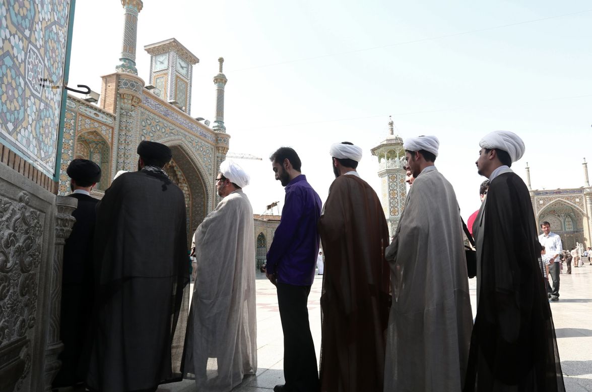 Iranian clergymen wait in line to vote at a polling station at the Massoumeh shrine on June 14. 