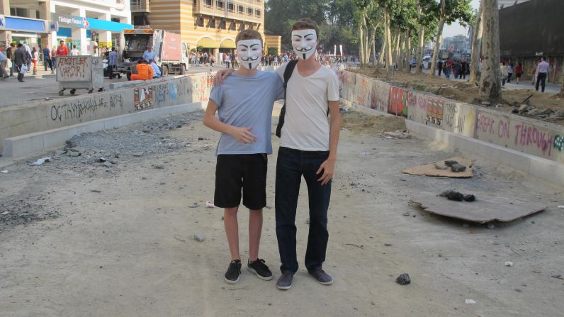 16-year-old twin brothers, Remi and Dilan (pictured right), holding spray cans and wearing the Guy Fawkes masks often used by Occupy protesters.