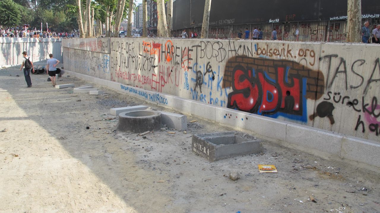 The two high school students walk down into a tunnel underneath Taksim Square after tagging walls nearby with graffiti.