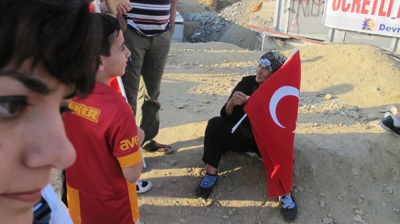 A woman in Taksim Square in Istanbul sells Turkish flags on Saturday, June 7, 2013 to visitors and protesters.