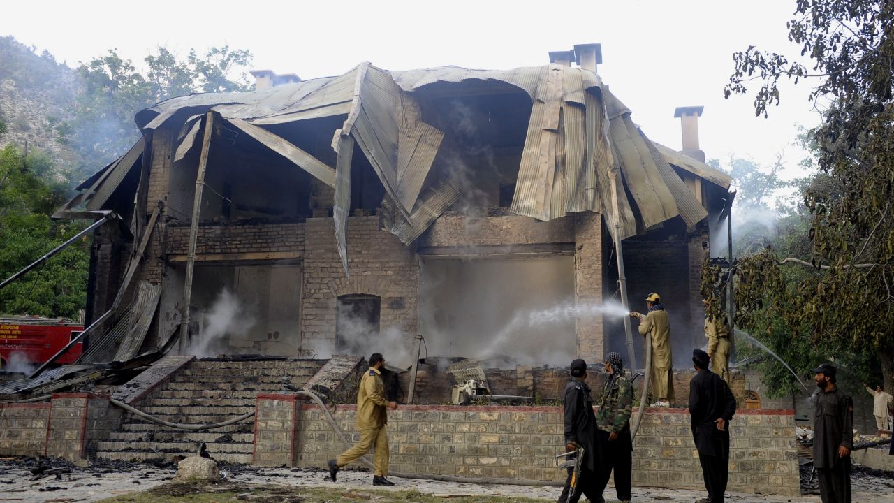 Pakistani firefighters extinguish a blaze which gutted a historical building in Ziarat, southeast of Quetta, on June 15, 2013. 
