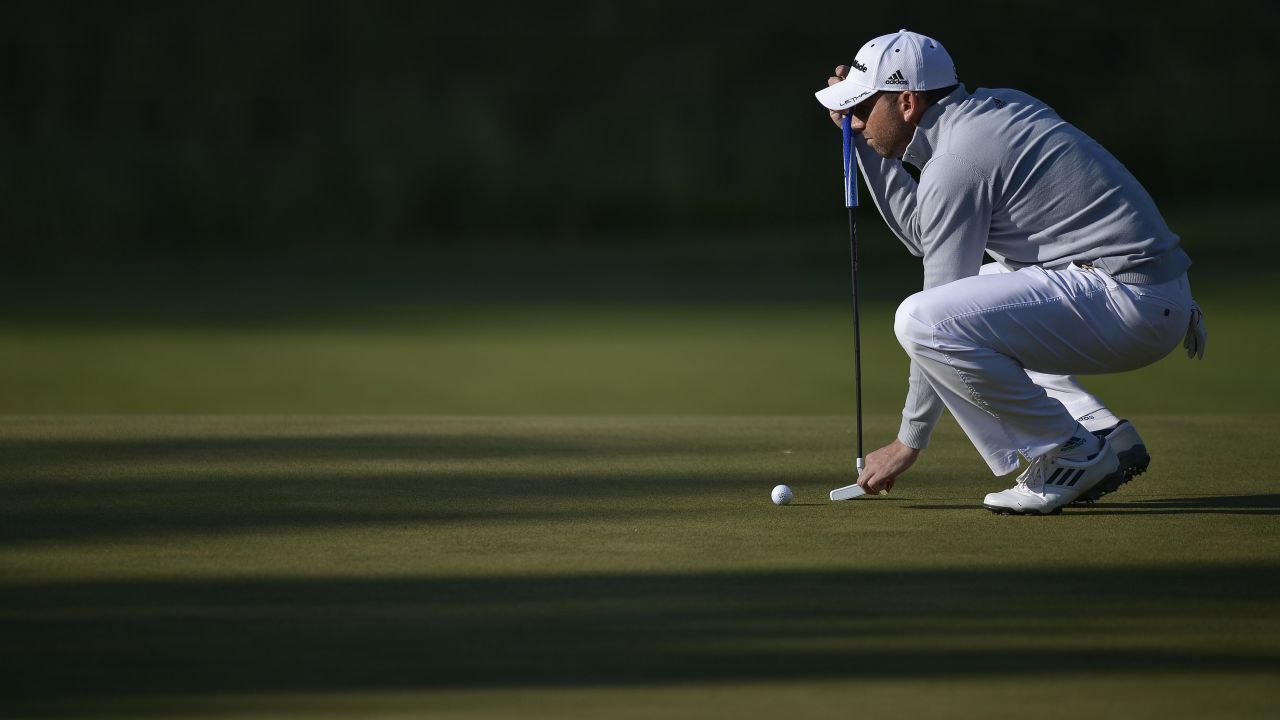 Sergio Garcia of Spain places a ball on the 17th green on June 15.