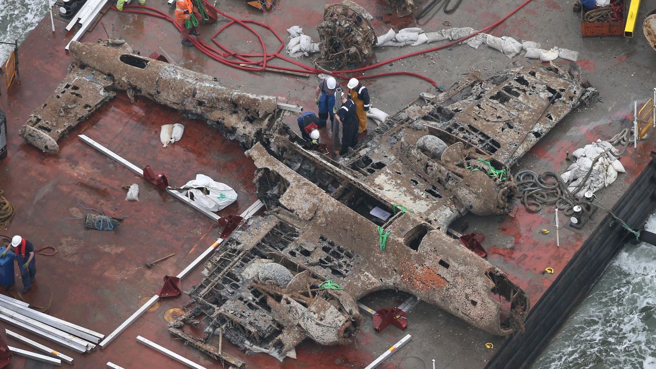 The wreck of the German World War II Dornier Do-17 plane is transported on a barge to a harbor near Ramsgate, England, on Tuesday, June 11. The bomber was shot down during the Battle of Britain in 1940.