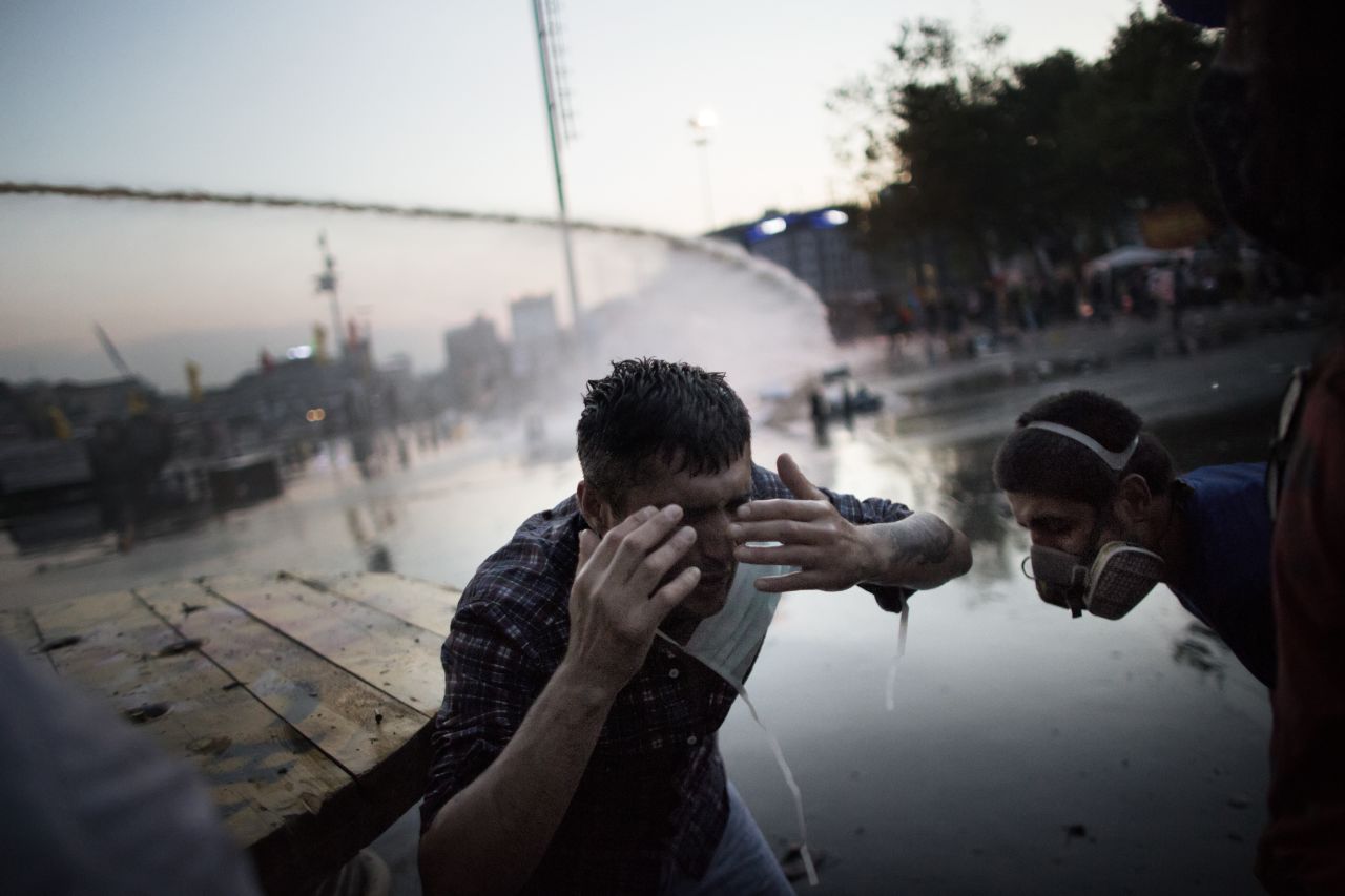 A protester on June 15, reacts in pain to a salvo of tear gas fired by Turkish riot police chasing out demonstrators in order to dismantle their tent camp in Gezi Park in Istanbul. 