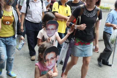 Ruth Jopling brought her daughters, Amber, 8, and Jade, 3, to the protest, who held cut-out masks on sticks bearing Snowden's image.  "It's not just about our generation, but the next generation as well," Jopling said.  Amber echoed her mother's sentiment: "When I grow up, I can tell my children about this."