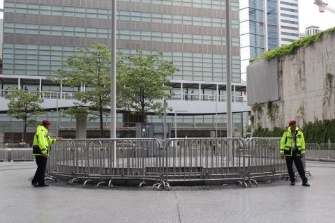 Police at the Hong Kong government headquarters in Tamar blocked off most of the square with two circles of fences, forcing protesters into a narrow outer perimeter.