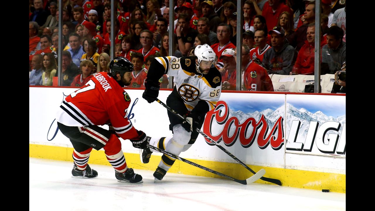 Brent Seabrook of the Chicago Blackhawks battles against Jaromir Jagr of the Boston Bruins for the puck.